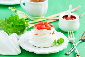 Dessert of meringue with rhubarb and mint sauce.