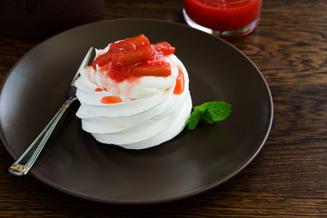 Dessert of meringue with rhubarb and mint sauce.