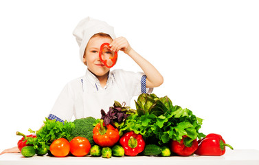 Young cook having fun with fresh vegetables