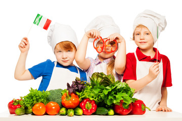 Three young cooks preparing Italian meal