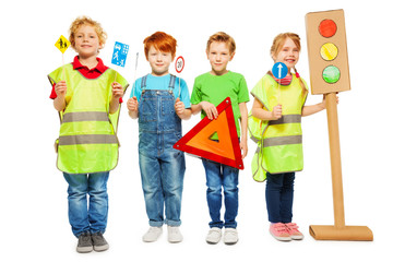 Group of four kids studying road safety rules