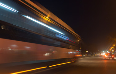 Fototapeta na wymiar the trace of a moving bus at night