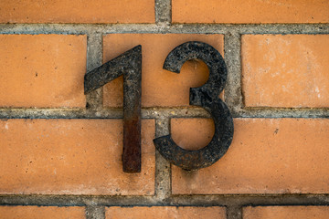 Number thirteen on a orange wall