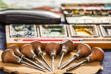Hand engraving tools on an artist's table