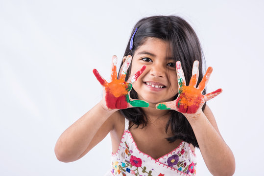 cute girl showing her colorful hands, surprised. Indian young girl with palm painted, asian girl and palm painting, palm printing