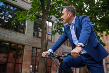 Fototapeta premium Relaxed man cycling in city