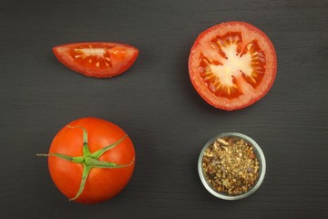 Ripe tomatoes with spices on a wooden board. Growing vegetables.