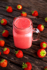 Strawberry smoothie in jar glass on wooden table. healthy food concept for breakfast or snack.