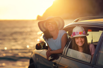 Mother with daughter travel by car on summer vacation