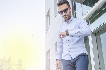 young businessman looking at his watch