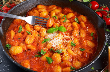 Homemade Italian Gnocchi with marinara sauce, cheese in iron pan