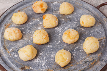 Brazilian snack cheese bread (pao de queijo) on oven-tray