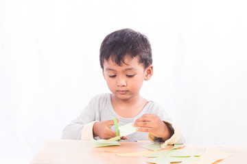 Boy play scissors cutting paper