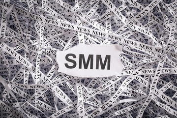 Closeup torn pieces and tapes of paper with the word SMM.