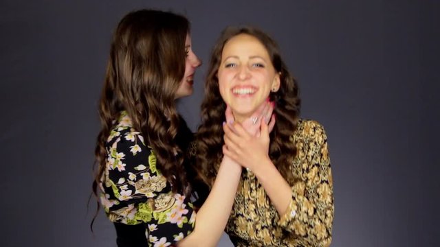 Girl jokingly strangle girlfriend.