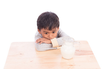 Cute little boy bored with milk