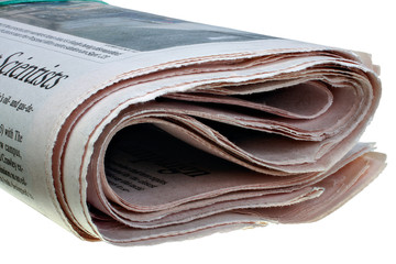 Folded newspaper isolated on the white background closeup