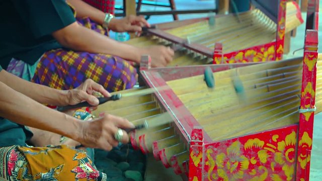 Local musicians playing a traditional, Balinese, stringed percussion instrument in a popular restaurant. Video UltraHD