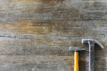 two size hammers on old wood background, copy space