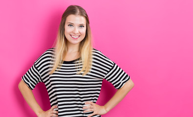 Happy young woman with pink background