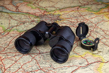 Binoculars and Compass on Old Route Map