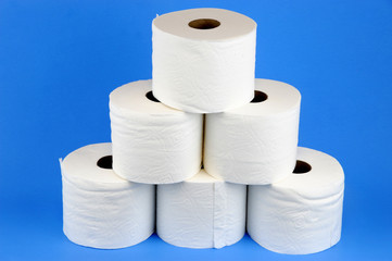 toilet paper rolls on blue background