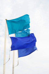 blue flags on the pole waving in the wind