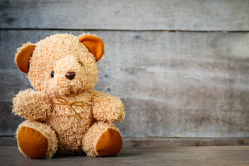 Cute teddy bears sitting on old wood background