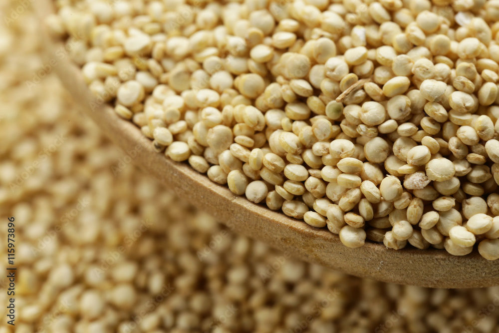 Sticker quinoa grain in a wooden spoon close-up shot