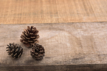 Pine cones on wooden background