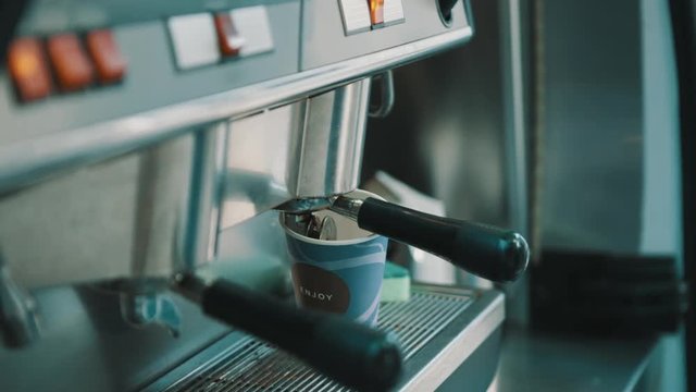 ARMAVIR, RUSSIA - JULE 16, 2016: Man the seller is making coffee in the coffee machine in the cafeteria