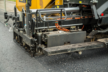 Road construction works with roller compactor machine and asphalt finisher