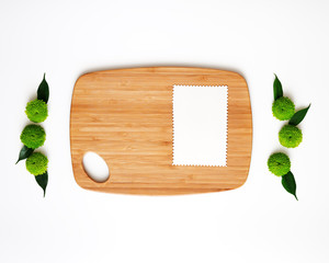 Wooden cutting board and paper with decoration.