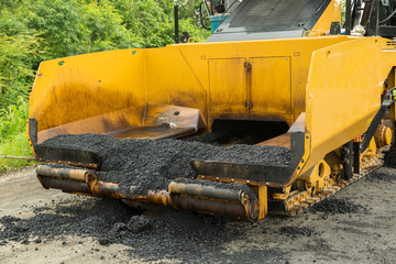 Road construction works with roller compactor machine and asphalt finisher