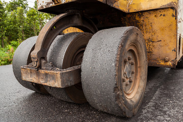 Road construction works with roller compactor machine and asphalt finisher