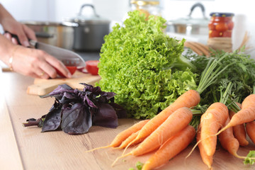 Cook's hands preparing vegetable salad - closeup shot