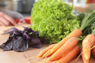 Cook's hands preparing vegetable salad - closeup shot