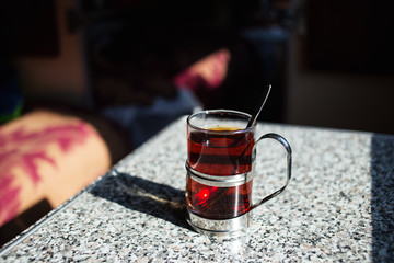 Tea in glass with coaster. Food second-class carriage