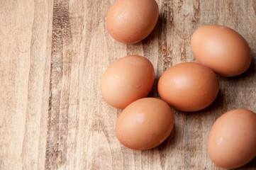 The image of eggs on a wooden table.