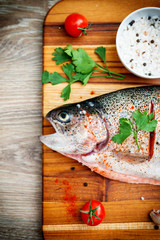 Raw trout on wooden background