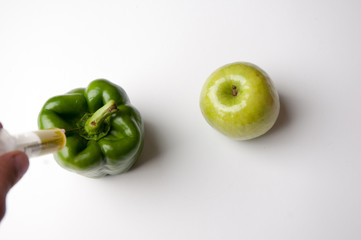 Pepper and apple infected gmo. White background.