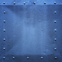 Riveted military or industrial plate. Metal background.
