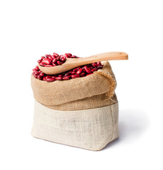 red  kidney beans in the sackcloth bag with wooden spoon isolate