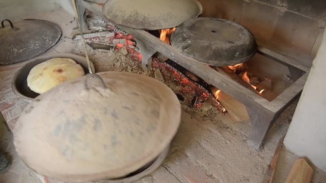 Baking of bread.Baking bread in a stone oven