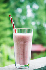 Strawberry milkshake on the rustic wooden background