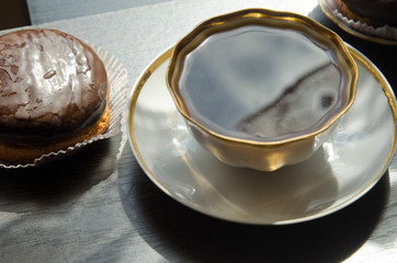 cup of coffee and chocolate cakes on a dark wooden table, for menus, calendars, illustrations