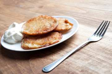 Potato pancakes on a wooden table. Background