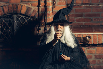 Old wizard with pendulum