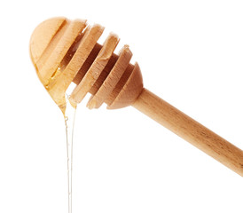 Honey dripping from wooden honey dipper