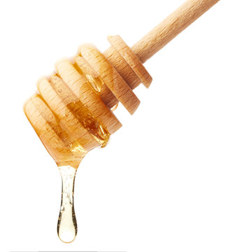 Honey dripping from wooden stick